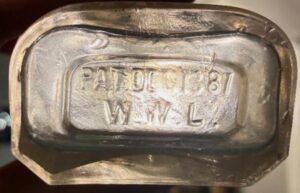 Base of NEWMAN / 5TH & WALNUT druggist bottle, marked with PAT DEC 13 87, and "W.W.L." (Photo courtesy of Miles Burke). 