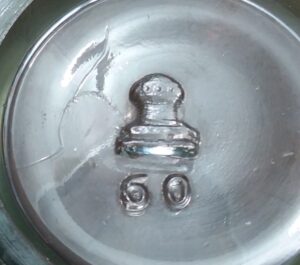 Capstan Glass Company mark - on the base of a small jelly glass -  representation of a ship capstan, also looks similar to a "Pawn" chess piece. Capstan Glass Company, Connellsville, Pennsylvania. (The "60" is a mold number or catalog item number). 