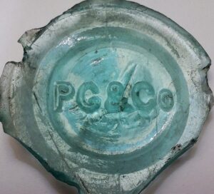 "P. G. & Co." on base shard of aqua bottle or jar sold by Peaslee Gaulbert & Company, Louisville, KY