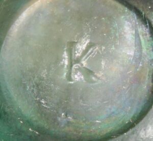 'K' mark on base of green-aqua glass antique ringed pepper sauce bottle, possibly product of Kearns, Zanesville, Ohio.