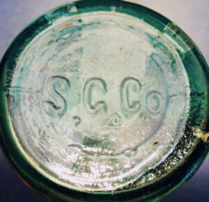 "S. G. Co." on base of aqua John J. Smith / Louisville, KY. bottle. Bottle made by Southern Glass Works/Company, of Louisville. 