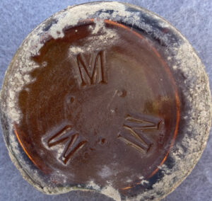 "M. M. M." mark in a circular formation - this bottle base was found in Arizona - uncertain meaning. This is probably a beer bottle base, perhaps dating from the 1895-1920 time period? (Photo courtesy of Lindsay Wygant).
