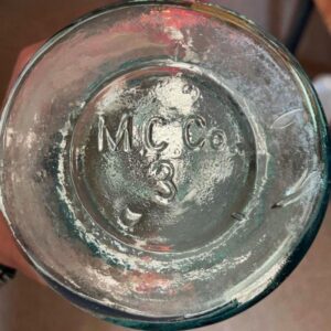 Base of aqua "M C CO" wax sealer fruit jar, probably circa 1880s. (Photo courtesy of Becca Hill)