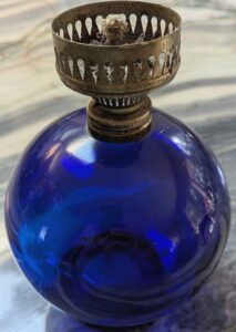 Cobalt blue mini-oil lamp with "Cross" emblem on base. The lamp likely dates from the 1970s,made in Hong Kong. Unknown mark - (Photo courtesy of Heidi Venture) 