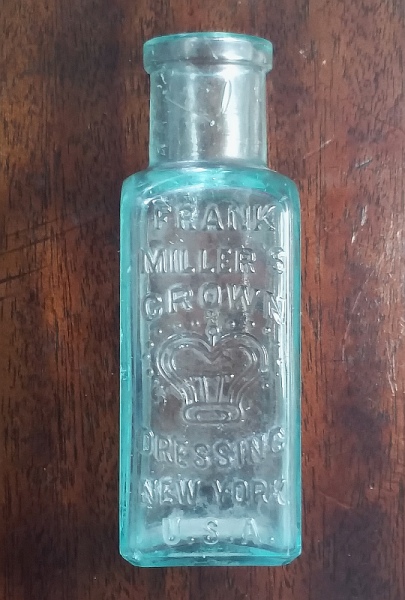 Antique aqua glass "FRANK MILLER'S CROWN DRESSING NEW YORK U.S.A." boot, shoe and leather dressing bottle, circa 1885. This example is marked with a mold number "23" on the base. Antique aqua glass "FRANK MILLER'S CROWN DRESSING NEW YORK U.S.A." boot, shoe and leather dressing bottle, circa 1885. This example is marked with a mold number "23" on the base.