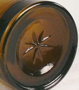 Star mark on base of olive amber cylinder whiskey - Western US glasshouse. (Photo courtesy of Bill Lindsey). Star mark on base of olive amber cylinder whiskey - Western US glasshouse. (Photo courtesy of Bill Lindsey).