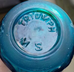 "TRIUMPH M S" on base of blue Seltzer style soda bottle - found in Hungary - Unknown meaning - photo courtesy of Laci (Fekete László Gyula, Magyarország - Salgótarján)