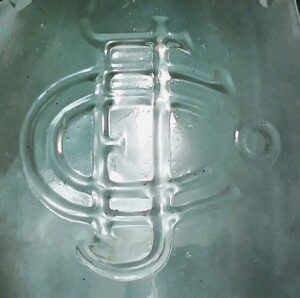 "C F J Co" monogram - as it appears on the face of a "MASON'S / CFJCo / PATENT NOV 30TH 1858" type antique aqua-colored fruit jar.