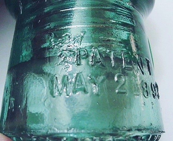Mold flaw creates an odd "Angel" image to the upper left of "PATENT" on this particular Hemingray No. 9 insulator. Weird "angel" mold flaw creates an odd image to the upper left of "PATENT" on skirt of Hemingray No 9 style telephone line insulator.
