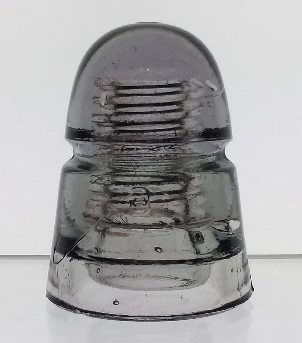 Light grayish-amethyst telegraph line insulator made by Brookfield Glass Company. This CD 145 "beehive" type has a "B" embossed on both the front and back, placed underneath the wire groove. Light grayish-amethyst telegraph line insulator made by Brookfield Glass Company. This type has a "B" on front and back, placed underneath the wire groove.