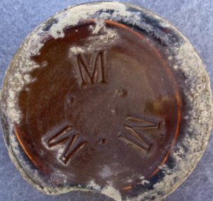 "M. M. M." mark in a circular formation - this bottle base was found in Arizona - uncertain meaning. This is probably a beer bottle base, perhaps dating from the 1895-1920 time period? (Photo courtesy of Lindsay Wygant).
