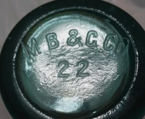 "M.B.& G.CO." ~ Massillon Bottle & Glass Company, Massillon, Ohio (22 is a mold number).